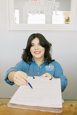 Chiropractic Jacksonville FL Assistant Handing Paperwork